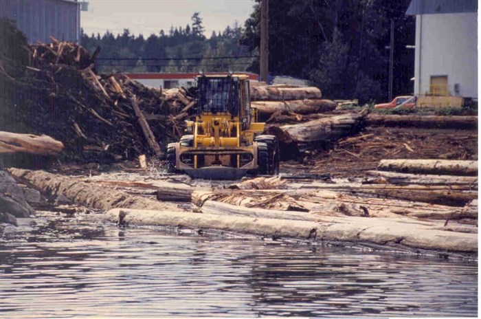 Heavy machinery at work with timber logs in the Campbell River estuary in the 1990s.