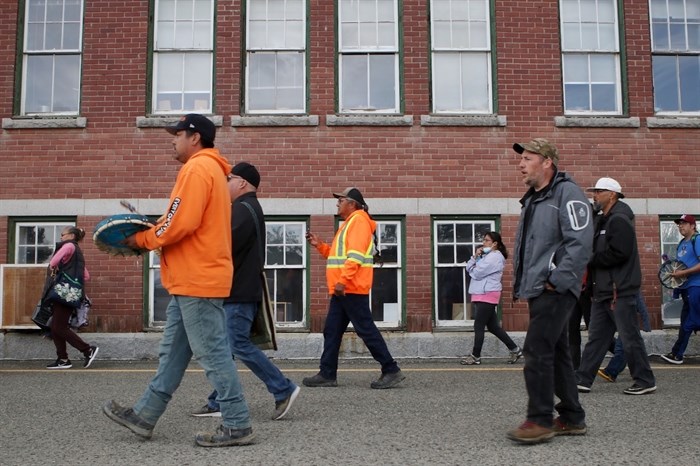 Hand drummers march past the Kamloops Indian Residential “School” in Secwepemc territory during the start of the 14th annual Spirit of syilx Youth Unity Run on June 3, 2022.