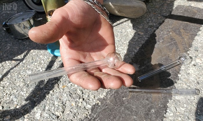 A homeless Penticton man named Eric holding a glass pipe. 