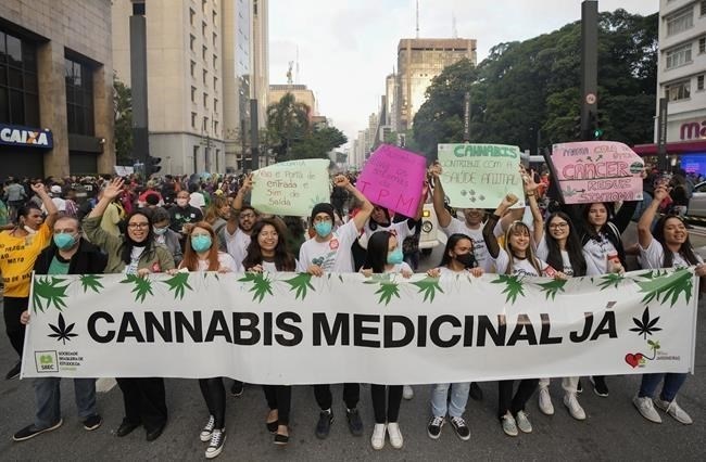 Demonstrators hold a banner that reads in Portuguese: "Medical Cannabis Now," during a legalization of marijuana march in Sao Paulo, Brazil, Saturday, June 11, 2022.