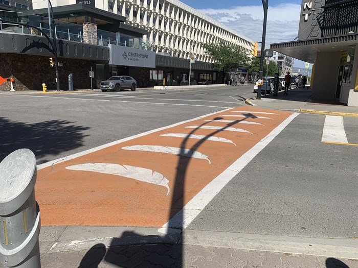 The downtown Kamloops orange crosswalk displays seven eagle feathers in a joint effort last spring to symbolize joint efforts toward reconciliation between the City and Tk'emlups te Secwepemc.