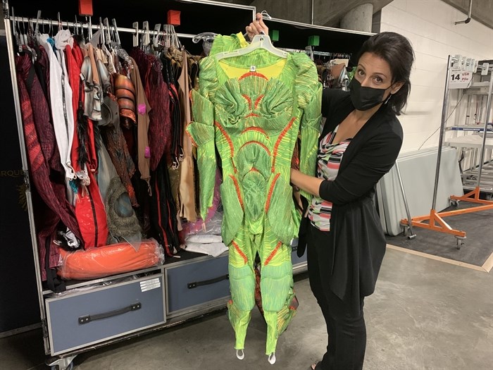 Senior publicist with Cirque du Soleil Janie Mallet hold up an insect costume at the Sandman Centre in Kamloops, June 23. 