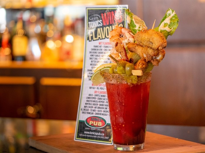 Tonics Pub & Grill is entering this beverage into Caesar Week in Kelowna. It mixes freshly-squeezed lemon and lime with some secret spices and liquid. It is topped with lemon pepper wings, steamed prawns, and a mini Caesar salad bite.