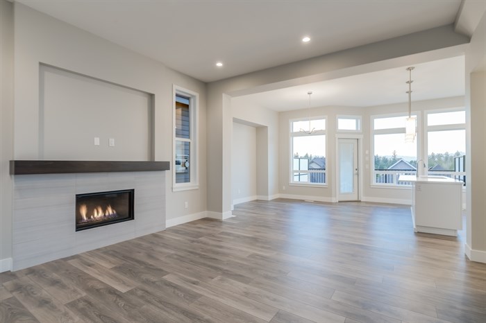 Interior of a modern living room with hardwood floors and fireplace.