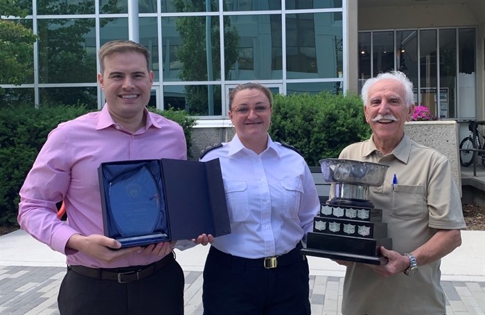 Penticton bylaw services manager Tina Mercier, centre, was presented the Kuo Cup by Penticton CAO Donny van Dyk, left, and Mayor John Vassilaki.