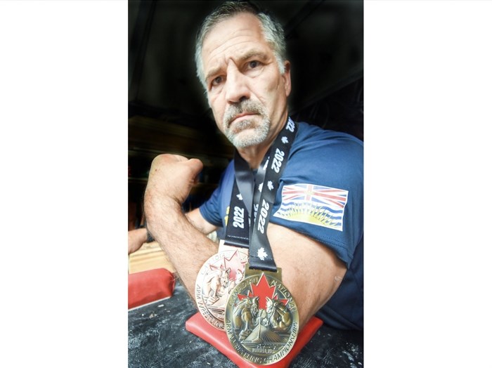 Penticton’s Richard Henson with the gold and bronze medals he won at the Canadian National Arm Wrestling Championships.