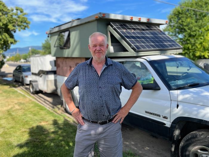 A man of god, Jeffrey Hincky stands outside his truck camper.