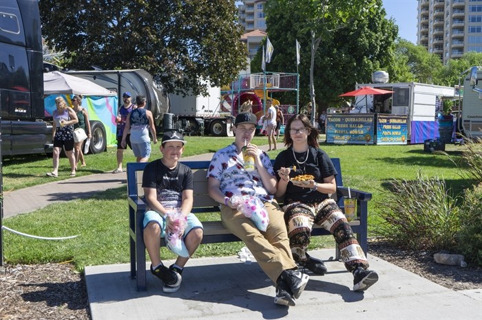 Three siblings from Penticton were enjoying some cotton candy and poutine on a bench at the Penticton Peach Festival.