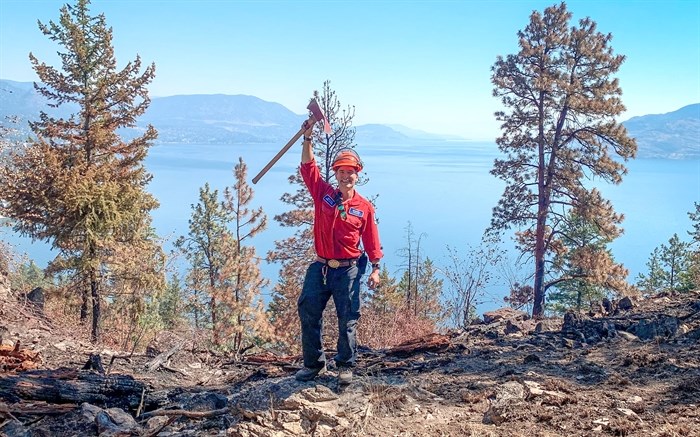 Penticton’s Mitch Taylor raises his axe in celebration of another job well done with the B.C. Wildfire Service. 