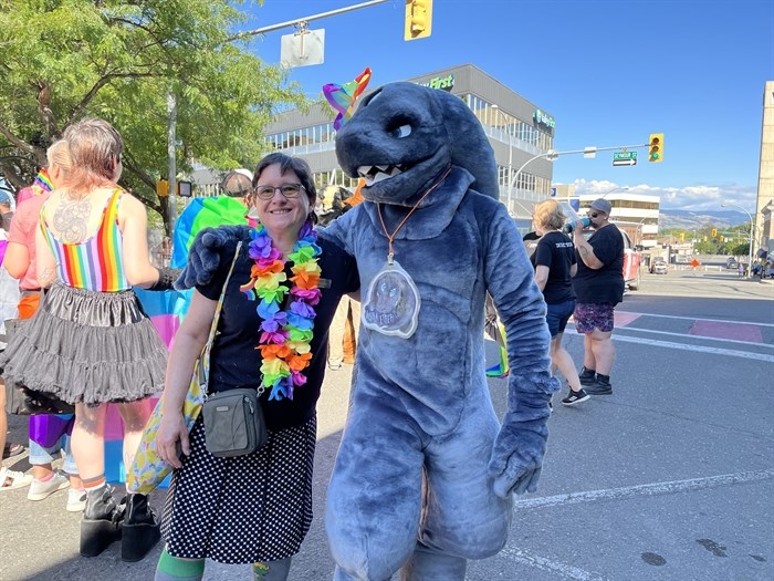 Former city councillor Nancy Bepple in the Kamloops Pride Parade on Aug. 28, 2022, beside a person in costume. 