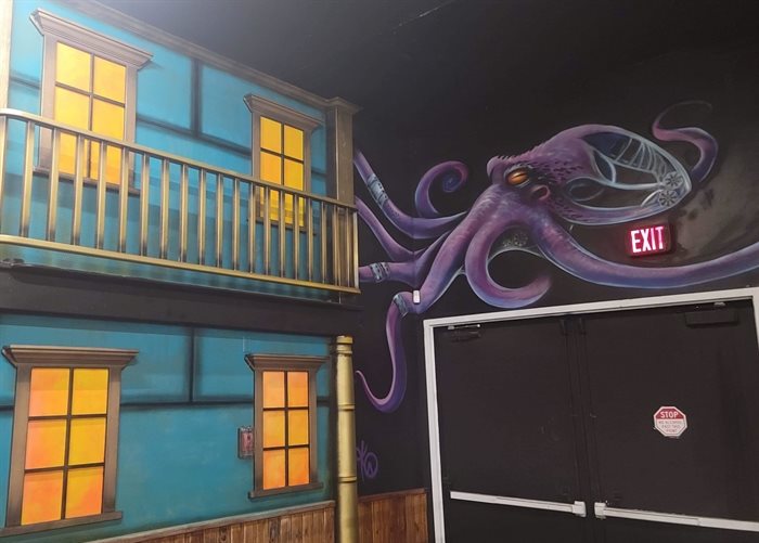 Mural of a steampunk style octopus with gears and a house by Kamloops artist Kelly Wright on the walls of Nightshift on Fifth in Kamloops.