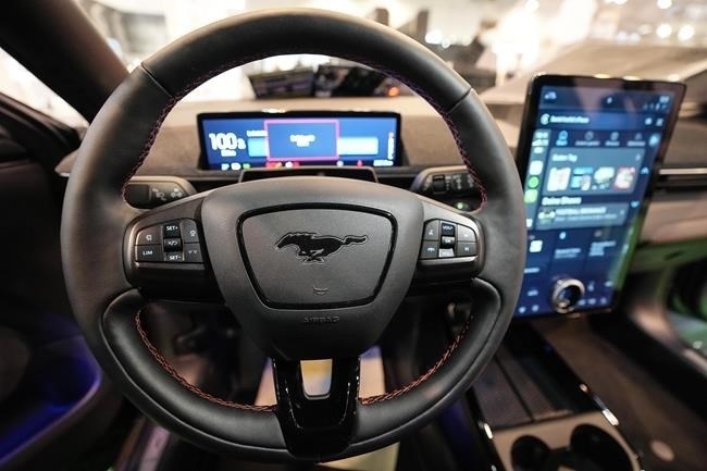 FILE - The cockpit of a Ford Mustang Mach-E electric car is pictured at the Motor Show in Essen, Germany, Thursday, Dec. 2, 2021.