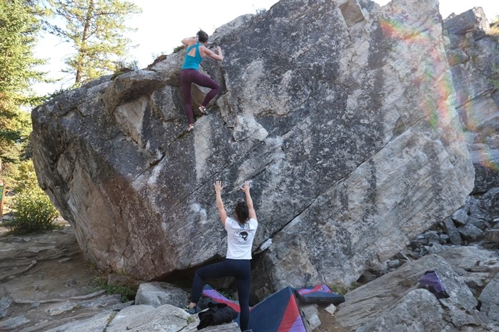 Climbers Moira Pearson and Kayla Chappell help each other out as spotters.