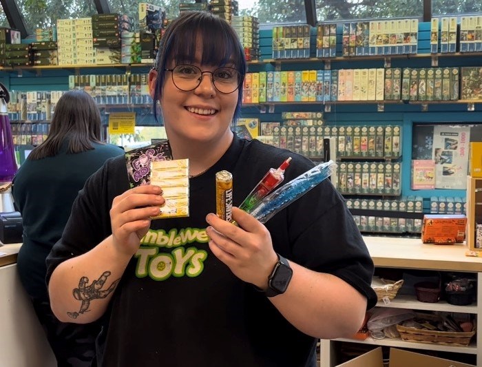 Tumbleweed Toys employee Keri-Ann Racicot holds up some of the retro candy for sale.