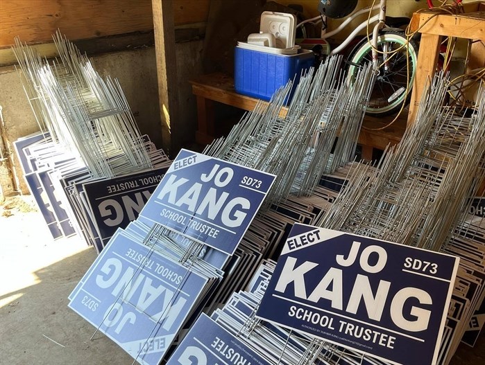 Campaign signs for School District 73 Trustee candidate Joe Kang. 