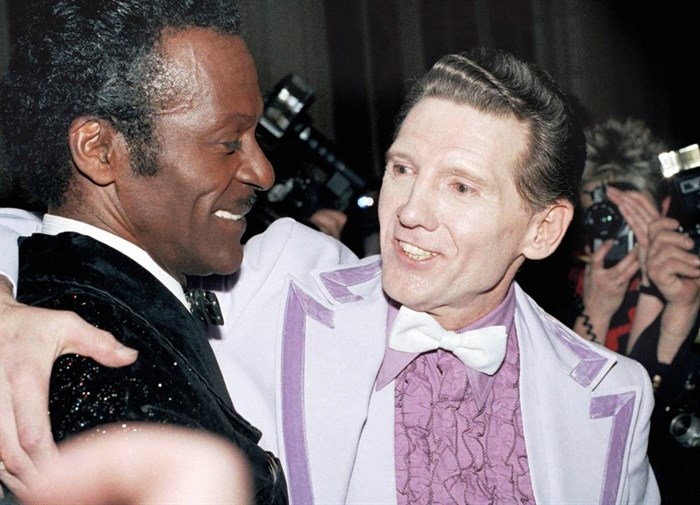 FILE - Chuck Berry, left, and Jerry Lee Lewis embrace at a reception at the Waldorf-Astoria in New York on Jan. 23, 1986. Spokesperson Zach Furman said Lewis died Friday morning, Oct. 28, 2022, at his home in Memphis, Tenn. He was 87.