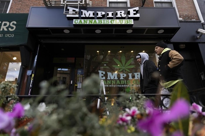 People walk past the Empire Cannabis Club, Wednesday, Nov. 16, 2022, in New York. Under pressure to launch one of the nation’s most hotly anticipated legal marijuana markets, the state Cannabis Control Board is set Monday to consider awarding some dispensary licenses to entrepreneurs and nonprofit groups — a major step that comes as cannabis regulators stress that they're trying to stop unlicensed sellers.