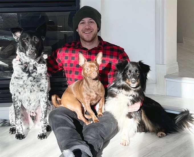 Penticton man Duffy Baker with his three dogs, including Henry on the far right. 