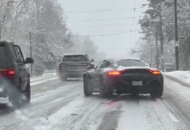 An Aston Martin struggles on an icy road in the Lower Mainland after the area was hit by more than 20 centimetres of snow overnight, between Dec. 19 and 20, 2022.