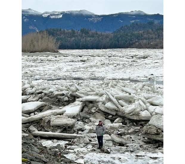 Rick Landreville stands in front of the largest ice piles he's ever seen in Agassiz.