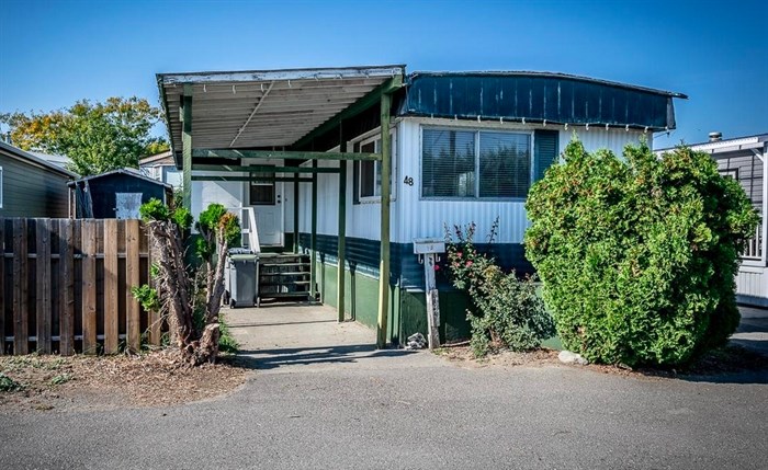 It is possible to buy a home for under $100,000, like this $99,000, 834 square foot, three bedroom manufactured home in Kamloops. But, for those with a medium household income, a small condo is likely a more attractive option.