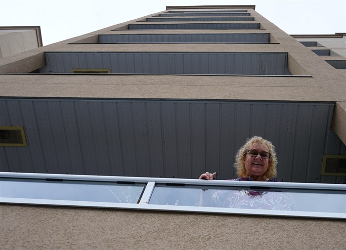 Toni Russell stands on the balcony of her Penticton condo.