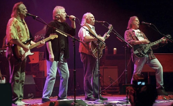 FILE - Stephens Stills, Graham Nash, David Crosby and Neil Young, from left, harmonize on a version of Young's 