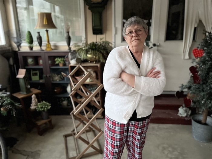 Carol Goldstone stands in her porch at the Crown Villa trailer park.