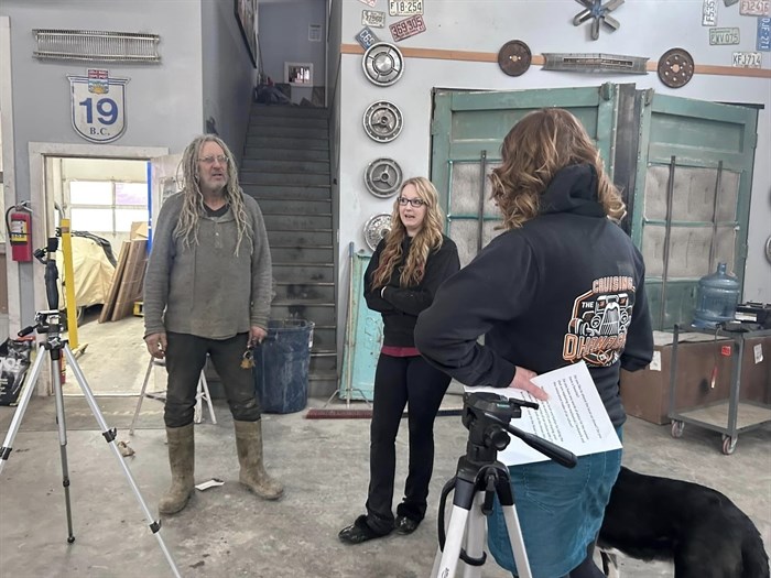 A film crew with an Okanagan-based company promoting car culture interviewing Mike Hall and Rust Bros Restoration parts person Sarah Ward as part of a video showcasing women in car culture. From left to right: Mike Hall, Sarah Ward, Anna-Marie Eckhart.