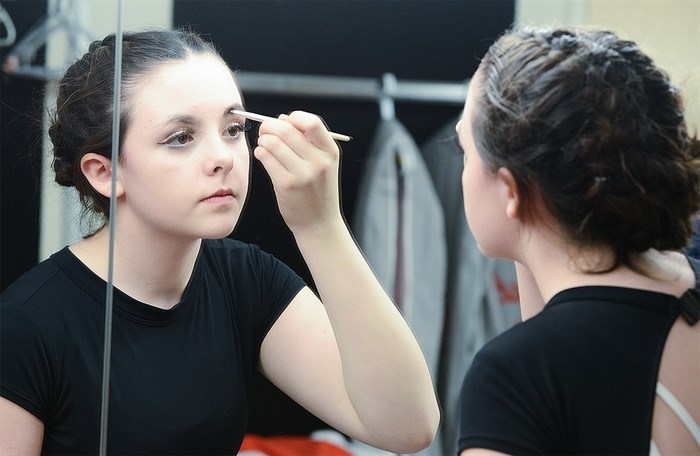 Elizabeth McGivern of the Tryzub Dance Socieity applies makeup prior to showtime.