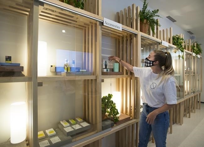 Employee Sophia Lovink arranges cannabis products at Dutch Love Cannabis Company in Toronto on Thursday, June 11, 2020. SNDL Inc. says it is buying four Dutch Love cannabis stores from Lightbox Enterprises Ltd.