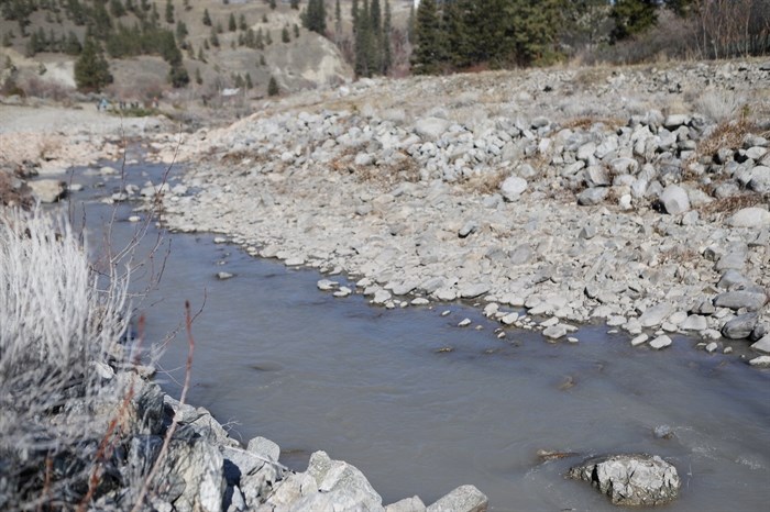 The cloudy waterway of nlux?lux??cwix (Trout Creek), downstream from its restoration site in the District of Summerland in syilx homelands on March 22, 2023.