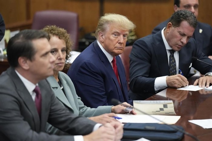 Former President Donald Trump sits at the defense table with his legal team in a Manhattan court, Tuesday, April 4, 2023, in New York.