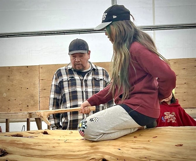 Carver Matt Jack, teaching a student to carve above, says protecting remaining and future artifacts from climate change disasters is critical, especially after First Nations culture was nearly erased by colonialism.