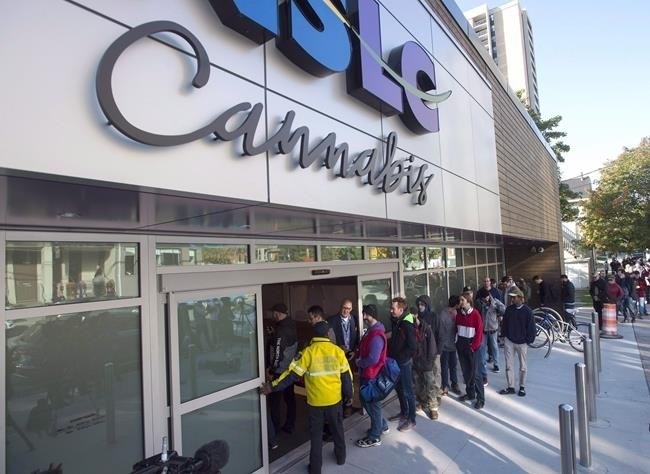 Customers enter the Nova Scotia Liquor Corporation cannabis store in Halifax on Oct. 17, 2018. A spate of cannabis store robberies has many in the industry calling for provinces to relax regulations requiring window coverings or cannabis to be kept out of sight of minors.
