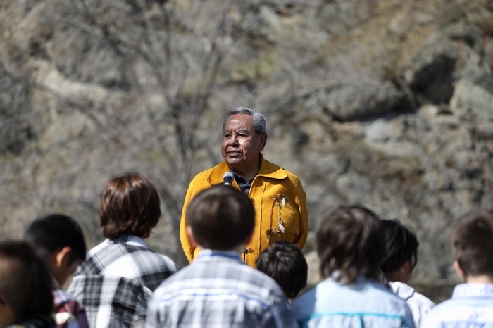snpinktn (Penticton) Hereditary Chief Adam Eneas speaks in front of Youth during the Osoyoos Indian Band’s celebration on April 14, 2023, of a reclaimed one acre of their original reserve land. 