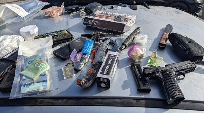 Weapons including a pistol, knives and a baton, along with cash and cellphones are some of the items that were seized.