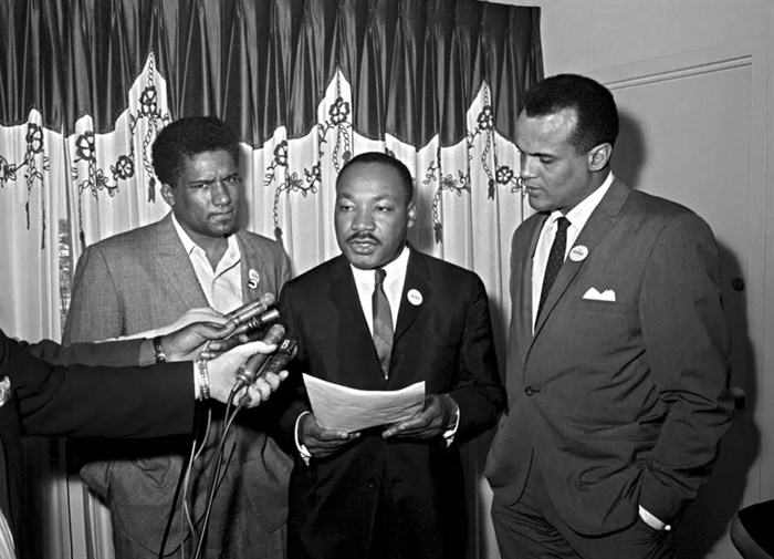 FILE - James Foreman, executive secretary of the Student Non-violent Coordinating Committee, left, Civil Rights leader Dr. Martin Luther King Jr., center, head of the Southern Christian Leadership Conference and activist-singer Harry Belafonte appear during a press conference in Atlanta on April 30, 1965. Belafonte died Tuesday of congestive heart failure at his New York home. He was 96. 