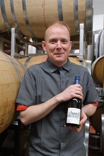 Josh the winemaker holds a 2020 Chardonnay 