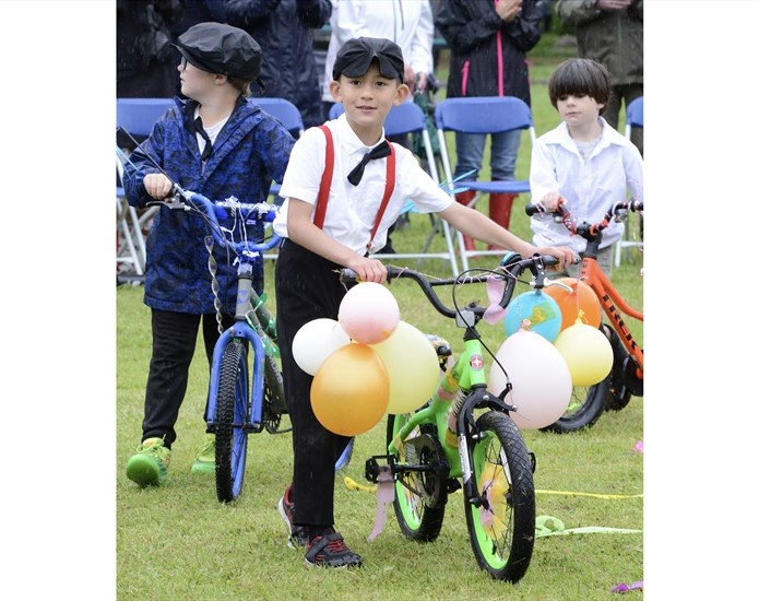 Entrants in the bicycle decorating contest led by Zachary Perez show off their creations.