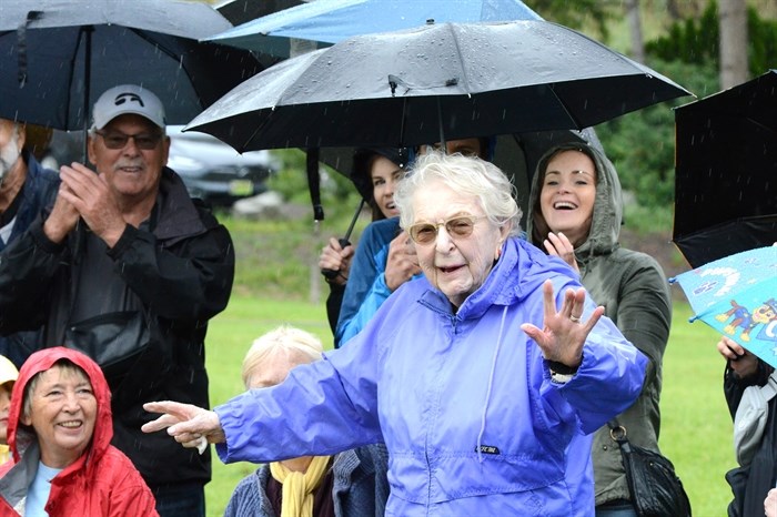 A flower girl in the 1925 Naramata May Day celebrations, Winifred Workman, now 104 years old, salutes the crowd at the 100th anniversary of the May Day event in the community Monday at Manitou Park.