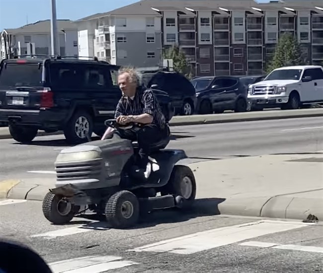 A man drove through a busy Kelowna intersection on a ride-on lawn mower.