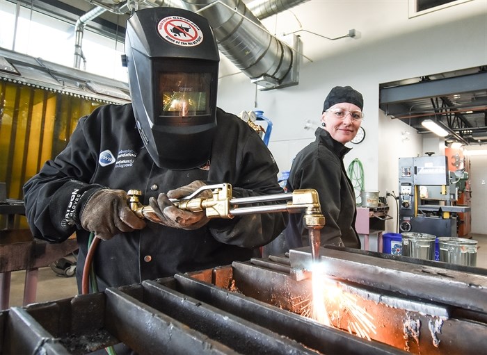 Instructor Kate Scorah watches as one of her students works on a project during the Women of Steel course at the Penticton Okanagan College campus.