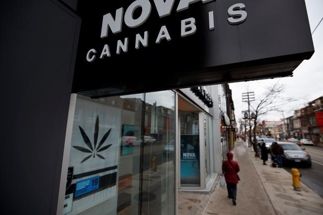 The Alcohol and Gaming Commission of Ontario is considering amending regulations that require cannabis store owners to ensure pot can't be seen from the exterior of their shop. Signage for a cannabis dispensary is seen among other shops on Queen St. in Toronto, Monday, Jan. 6, 2020.