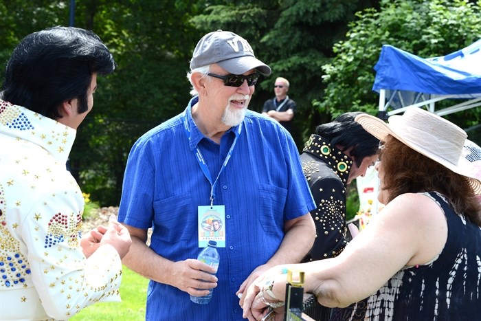 Former Elvis Presley personal bodyguard Sam Thompson talks with people about his time with the King to those attending the outdoor competition at the Penticton Pacific Northwest Elvis Festival Saturday. 