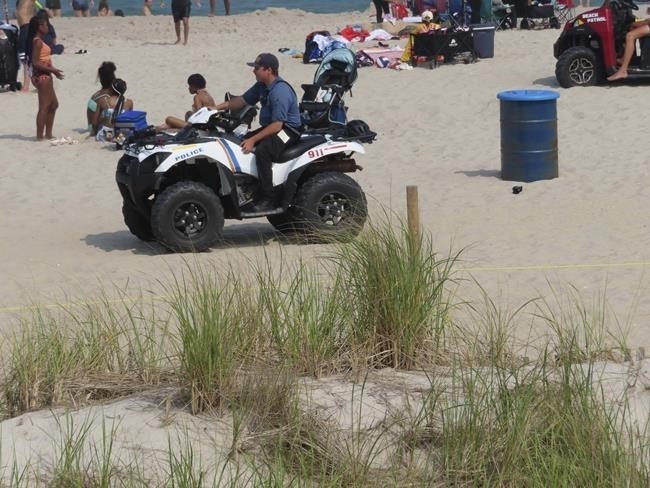 A police officer in a dune vehicle patrols the beach in Seaside Heights, N.J., on Thursday, June 29, 2023. Officials and residents of several New Jersey shore towns say the state’s law decriminalizing marijuana use is having an unintended effect: emboldening large groups of teenagers to run amok on beaches and boardwalks, knowing there is little chance of them getting in trouble for it.