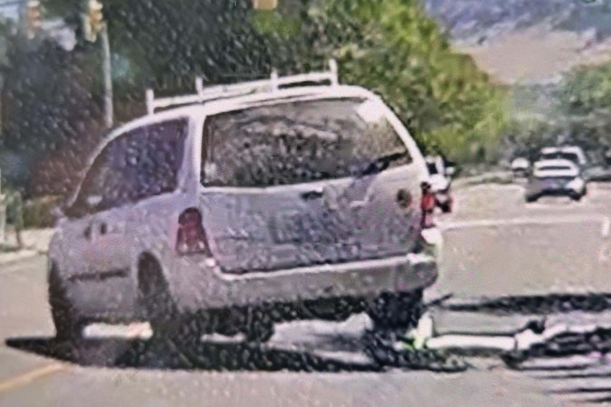 A white minivan fled the scene after striking a cyclist in Kelowna on July 16, 2023.