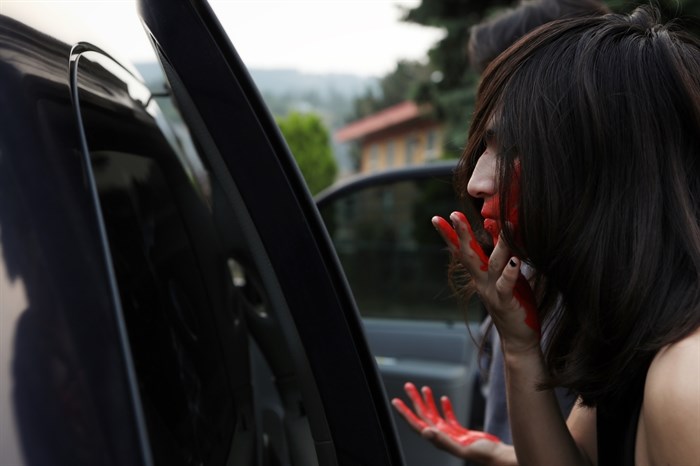 Shane Potts, the son of Caitlin, paints a red-handprint over his mouth to show solidarity for his missing mother, during a vigil in her honour that was hosted in Enderby on the Bawtree Bridge in Secwépemc homelands on July 13, 2023.

