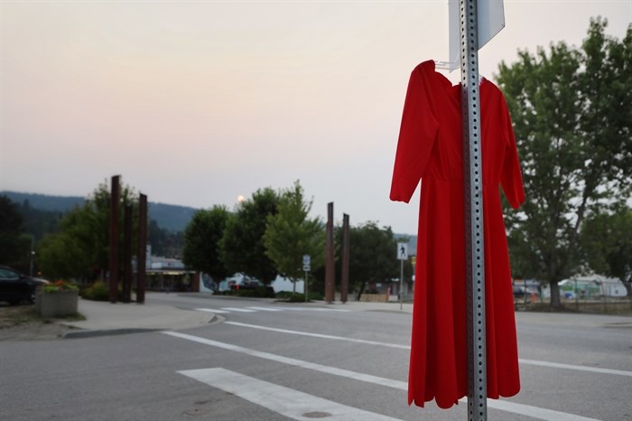 A red dress to honour missing and murdered Indigenous women, girls and Two-Spirit people (MMIWG2S) hangs from a stop-sign in Enderby in Secwépemc homelands on July 13, 2023.