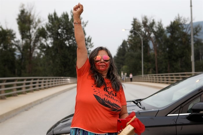 Jody Leon of the Splatsin First Nation stands in the middle of a roadblock that was organized during a vigil for Caitlin Potts on the Bawtree Bridge in Enderby in Secwépemc homelands on July 13, 2023.